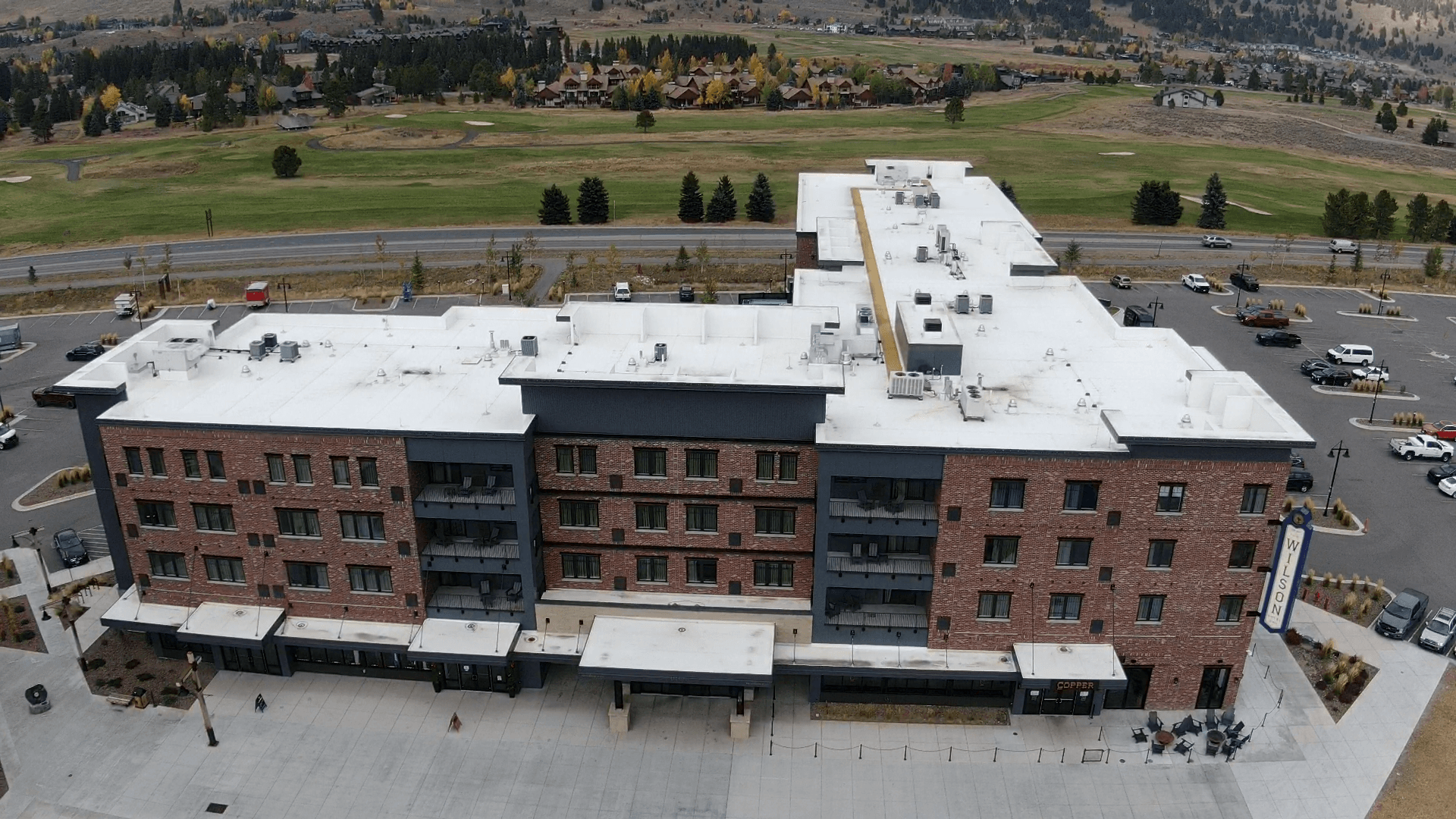 Frontal aerial view of building with white roof — Missoula, MT — Summit Roofing