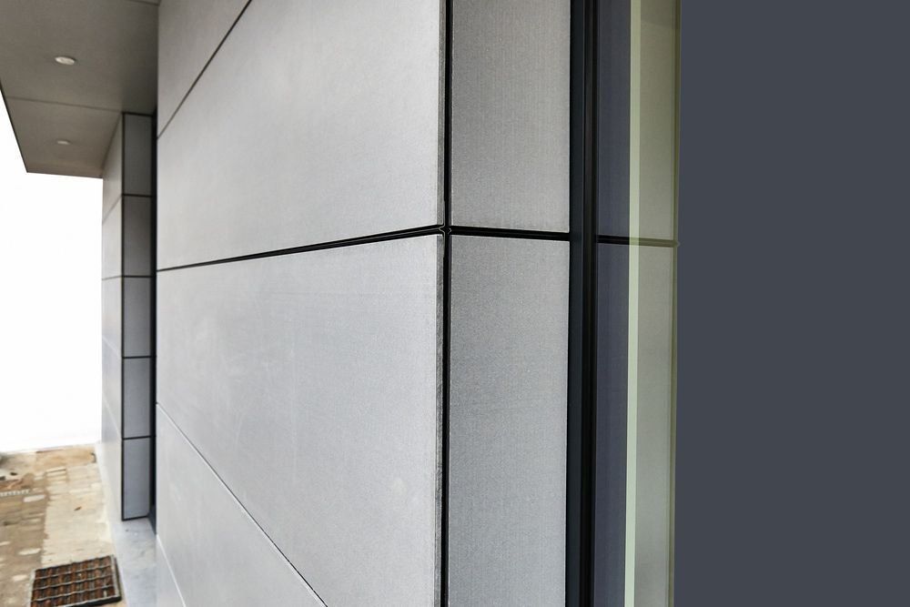 A Close Up of a Building With a Gray Wall and a Window — Rhythm Roofing in Grafton, NSW