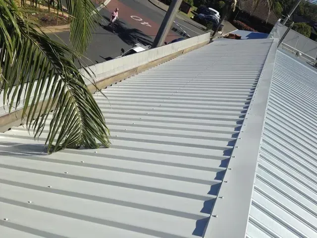 A Gray House With Two Windows and a Red Roof — Rhythm Roofing in Kempsey, NSW