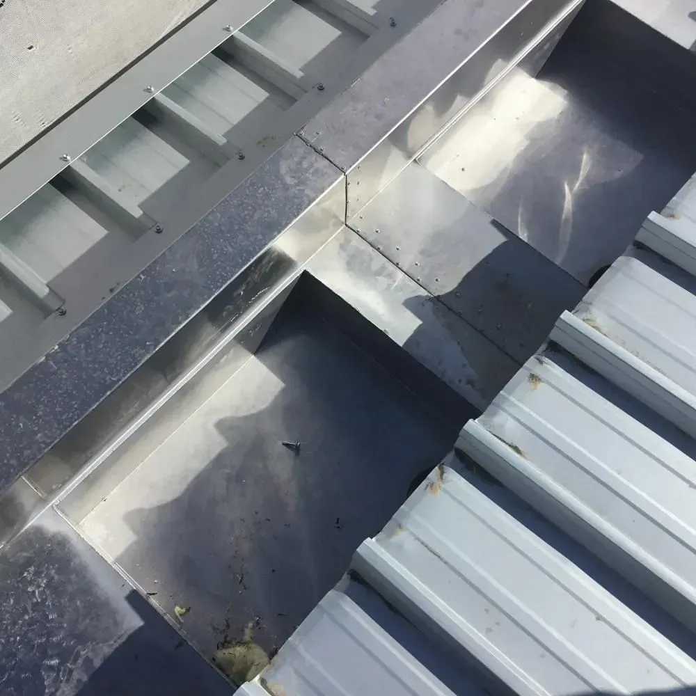A Close Up of a Metal Gutter on a Roof — Rhythm Roofing in North Boambee Valley, NSW