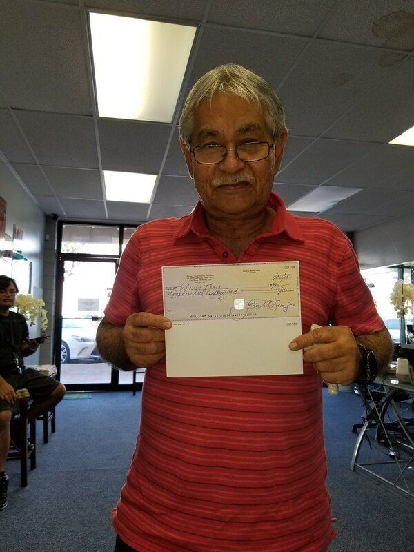 Man Wearing A Red Shirt — Ewa Beach, HI — Hawaii Gold Buyers Exchange