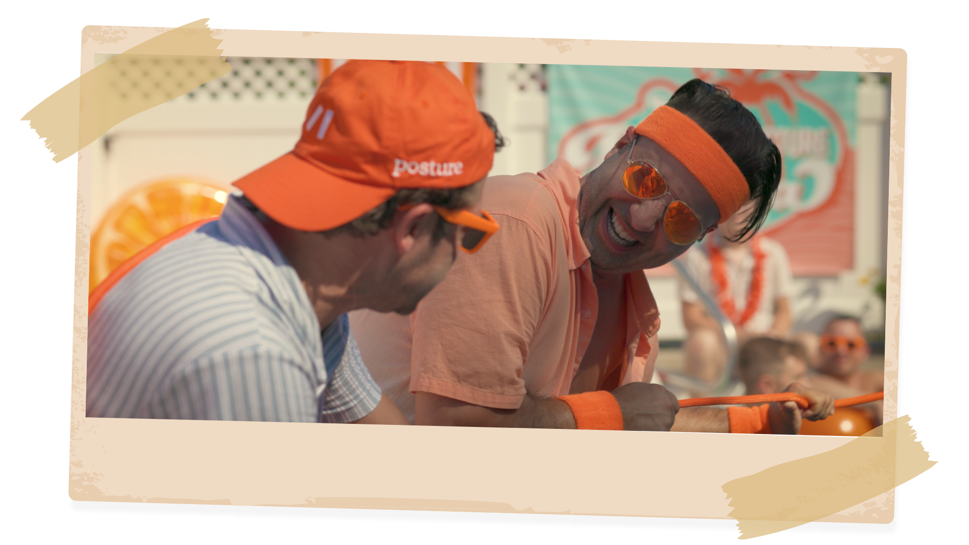 Two men wearing orange hats and headbands are standing next to each other.