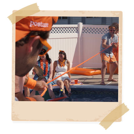 2 men playing tug of war around a pool