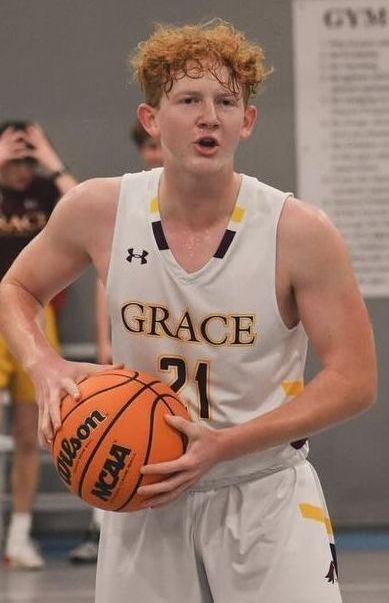Basketball player in a white and gold jersey with