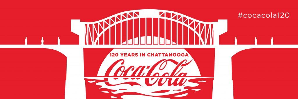 Coca-Cola logo in white, with the silhouette of a bridge, red background. 