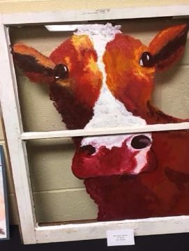 Painting of a cow's face framed by a white window. It is reddish-brown with a white stripe down its face.