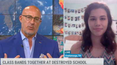 Man in blue blazer interviews teen girl in front of photos; title: Class bands together.