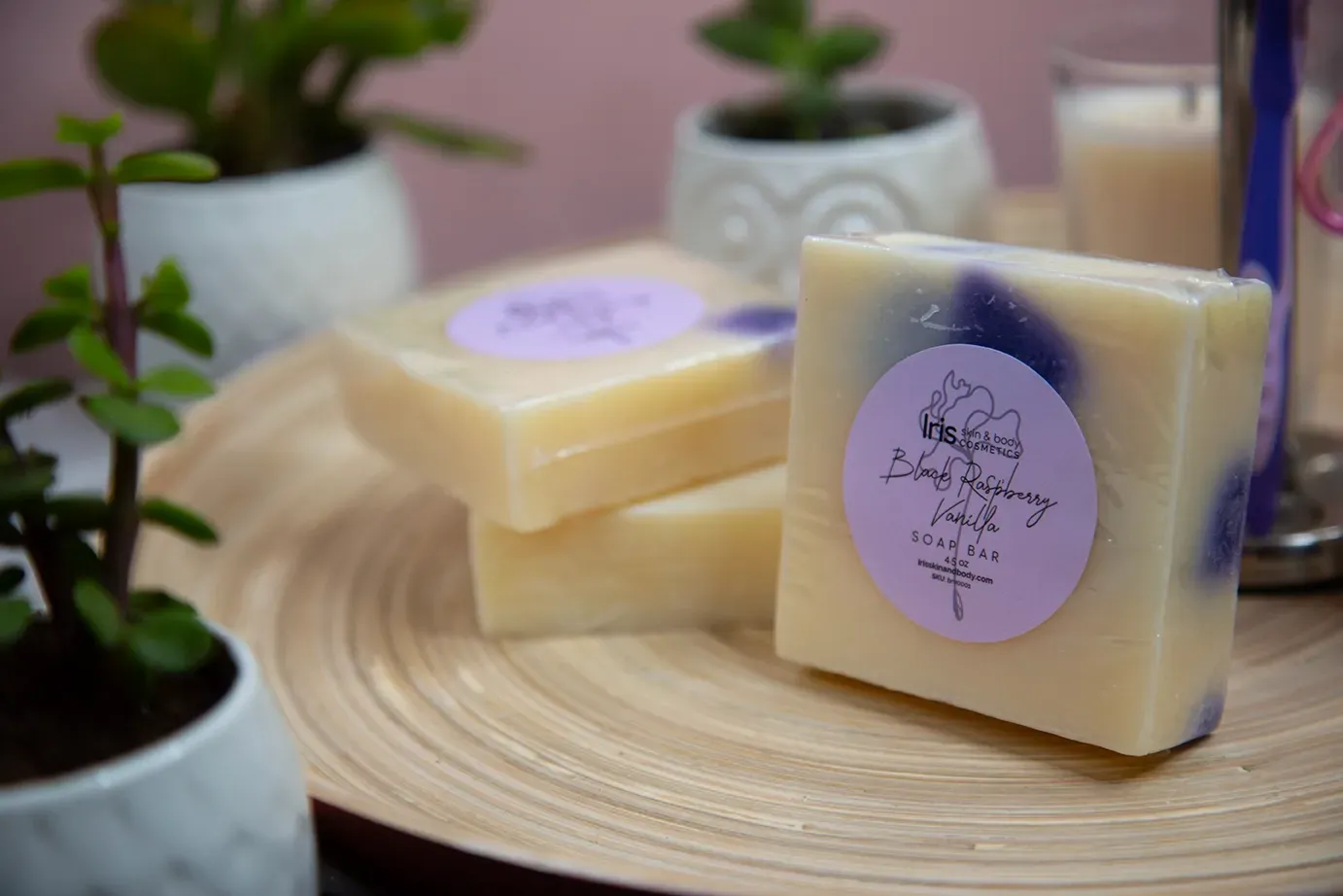 A stack of soap bars sitting on top of each other on a wooden table.
