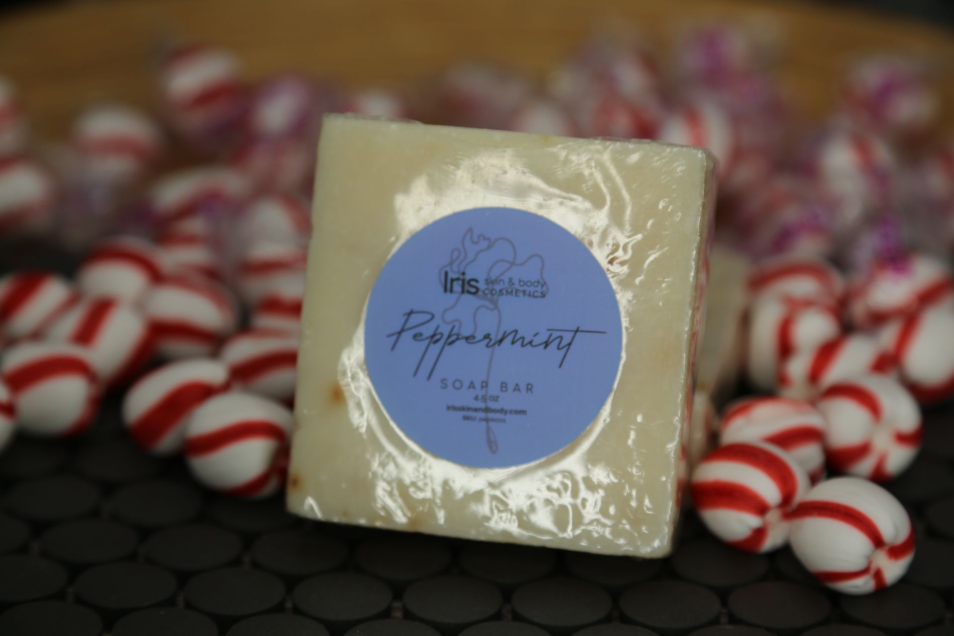 A peppermint soap bar is surrounded by candy canes