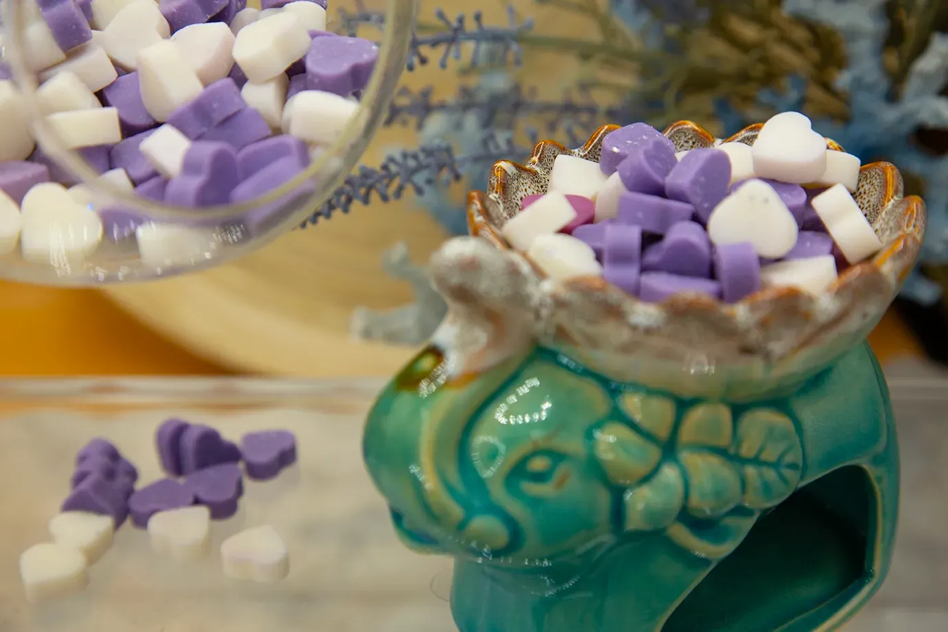 A turtle shaped wax burner filled with purple and white wax melts.
