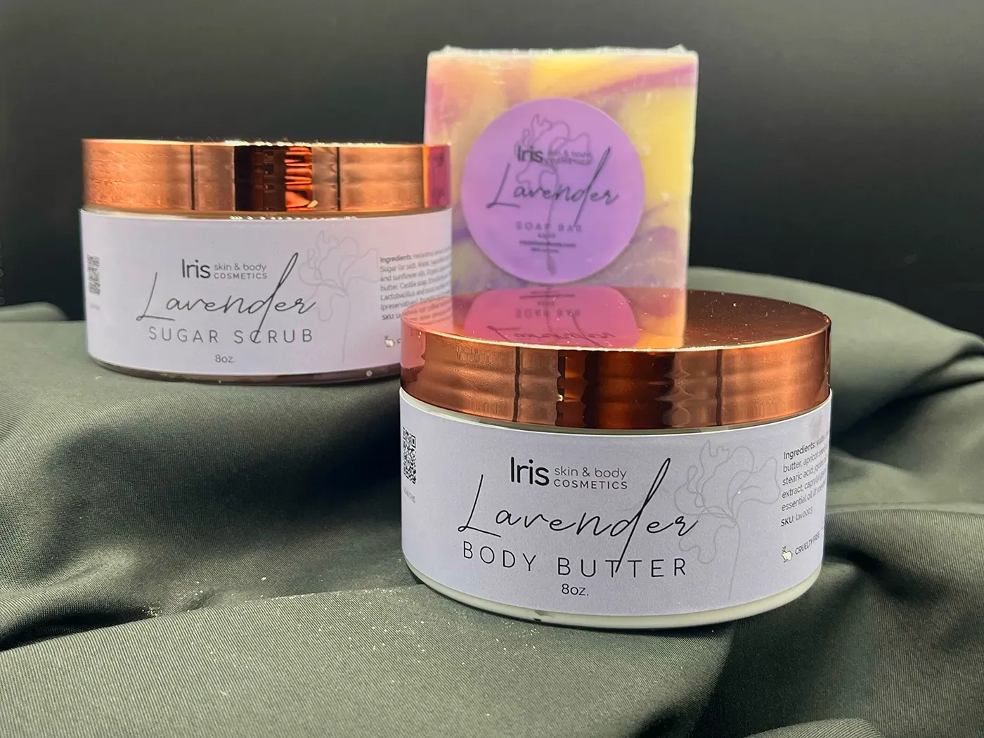 A jar of body butter and a bar of soap are sitting on a table.