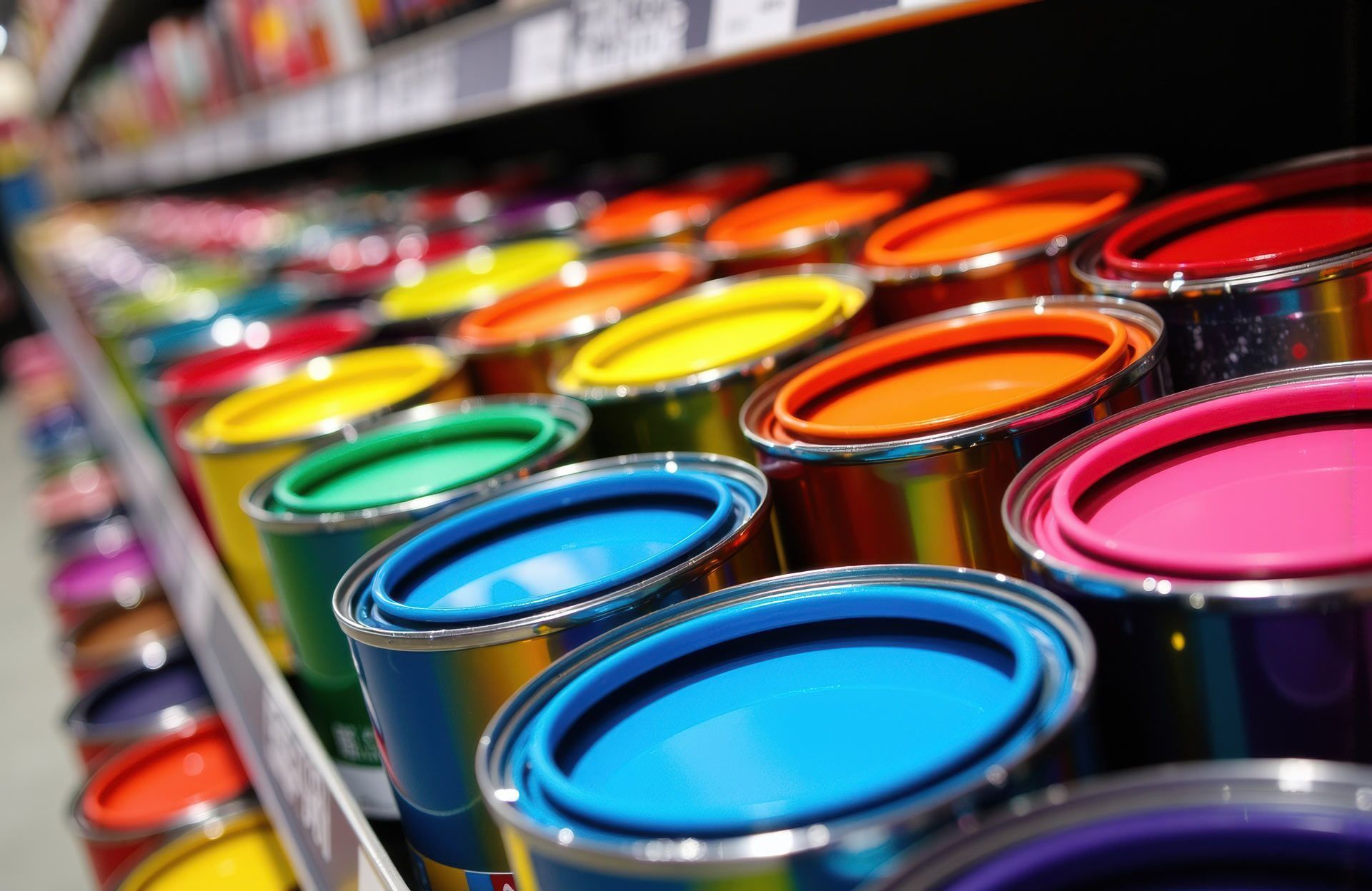 Colourful paint cans arranged on a store.