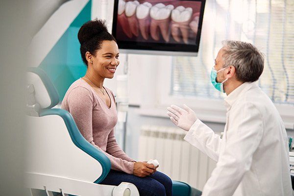 Woman Talking to Her Dentist — Albuquerque, NM — New Mexico Endodontic Specialists Woman Talking to Her Dentist — Albuquerque, NM — New Mexico Endodontic Specialists