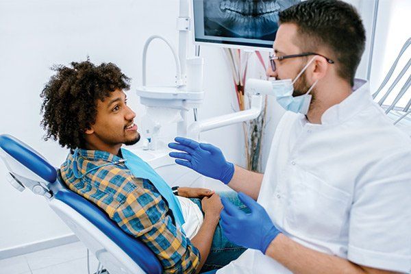 Patient Being Examined by Dentist — Albuquerque, NM — New Mexico Endodontic Specialists Patient Being Examined by Dentist — Albuquerque, NM — New Mexico Endodontic Specialists