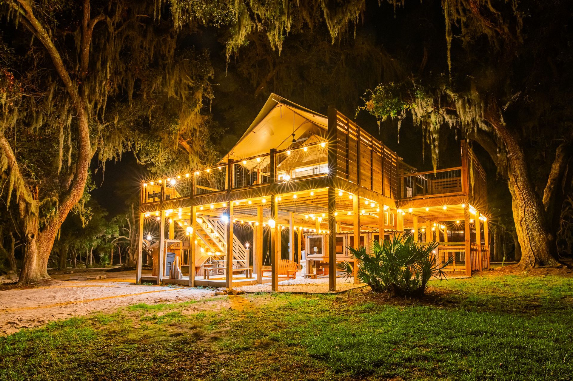 Wooden structure with string lights at night.
