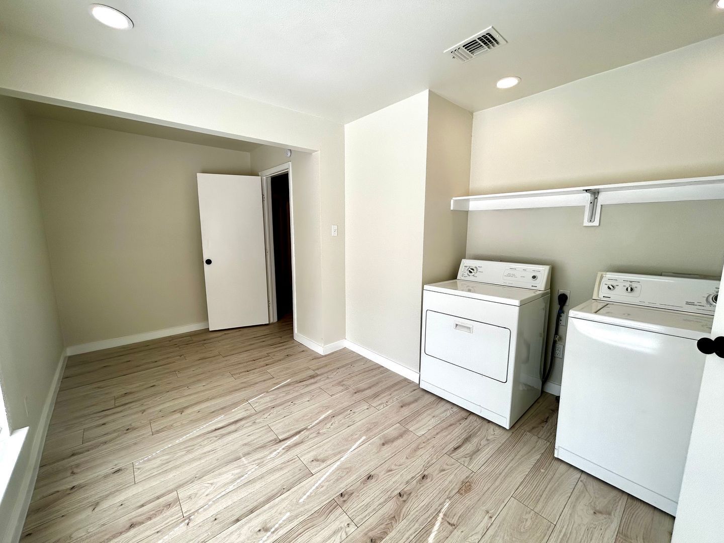 A laundry room with a washer and dryer side by side. 