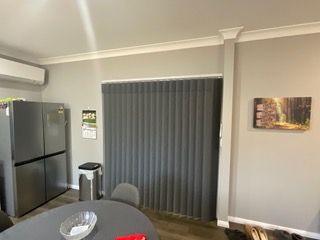 A living room with a table , chairs , refrigerator and blinds — Plantation Shutters in Singleton, NSW