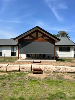A large white house with a wooden gazebo in front of it — Plantation Shutters in Singleton, NSW