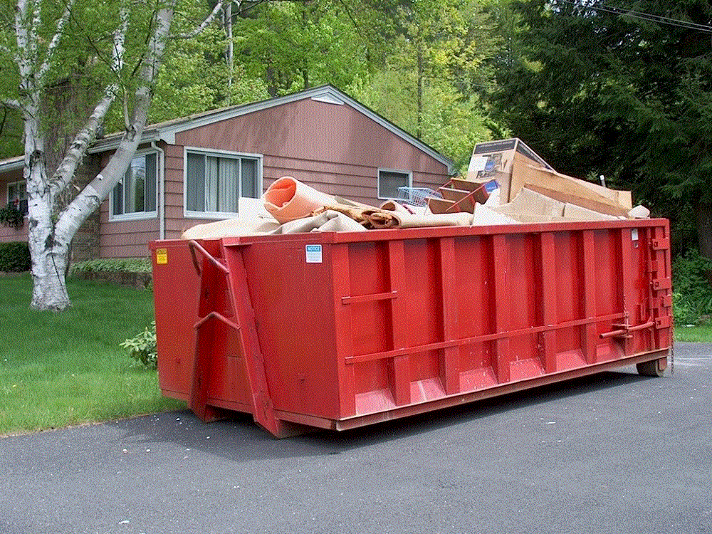 a truck is parked on the side of the road next to a fallen tree .