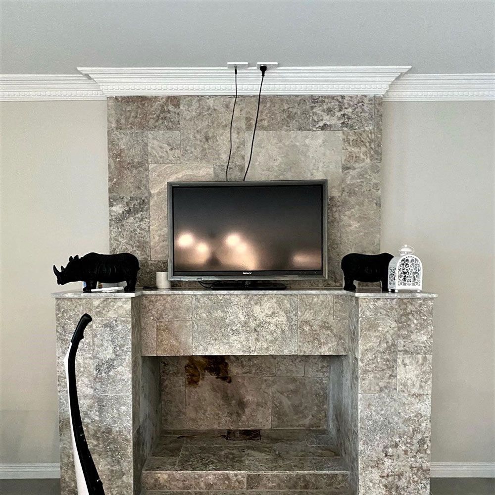 A living room with a fireplace and a flat screen tv
