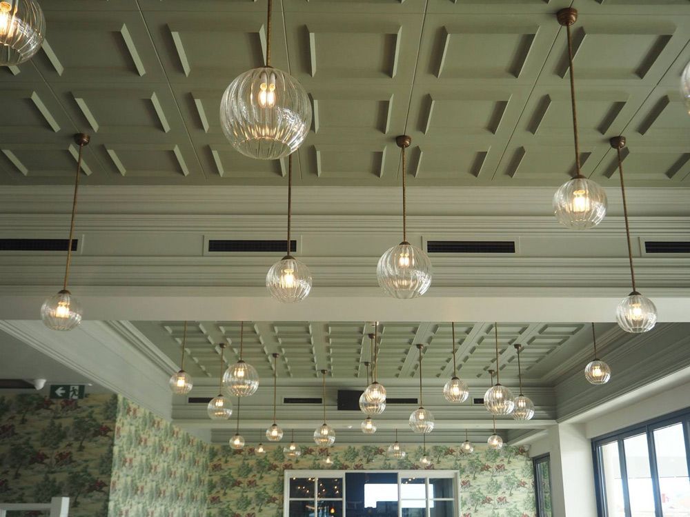 A room with lots of lights hanging from the ceiling