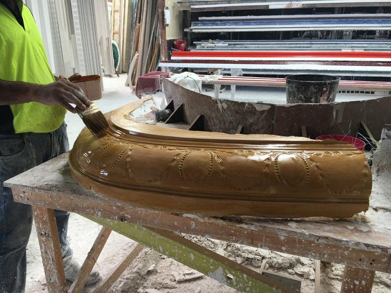 Painting on Curved Cornice — Manufacturing Cornices in Logan Village, QLD