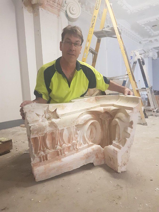 Worker Showing Column Cornice — Manufacturing Cornices in Logan Village, QLD