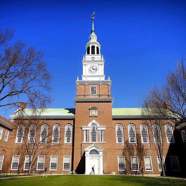 A beautiful brick building with a clock tower on a college campus.