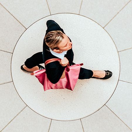 an aerial view of a woman walking through a college common area