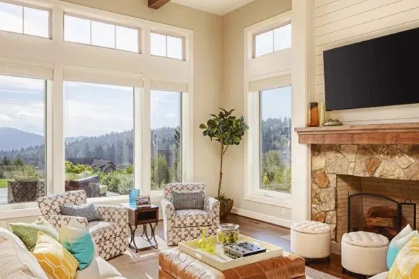 Handsome young man installing bay window in a new house construction site