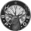 A circular black and white logo featuring a deer head centered in front of a clock face, with the letters