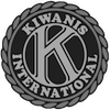 Grayscale Kiwanis International logo featuring a stylized letter K inside a circular, rope-patterned border.