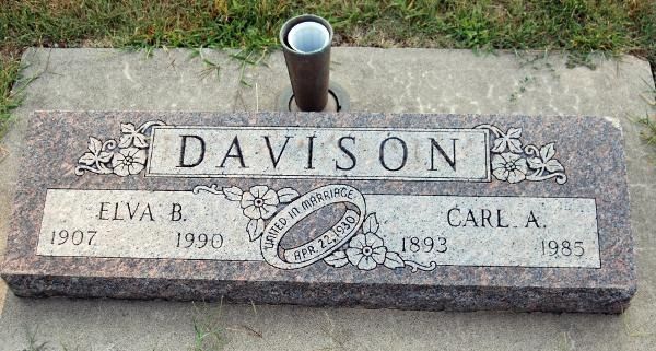 Granite grave marker for the Davison family with names Elva B. (1907–1990) and Carl A. (1893–1985) and a central ring motif.