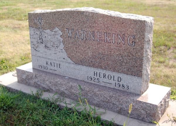 A granite Warneking family headstone with engraved names Katie (1930–) and Herold (1925–1983) in a grassy cemetery.