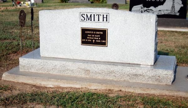 A gray stone grave marker engraved with 