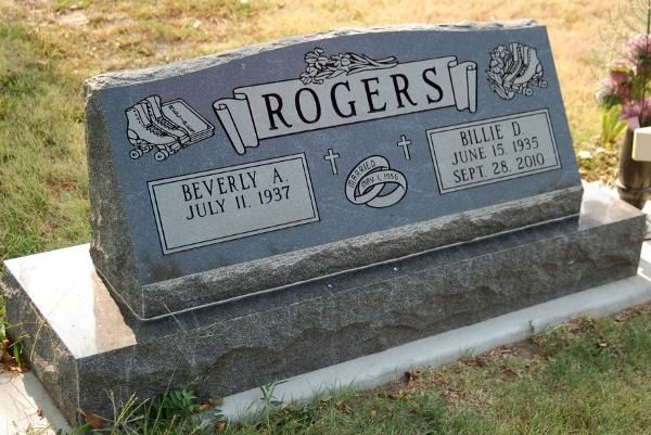 A gray granite double headstone for the Rogers family with names and dates for Beverly A. and Milo D. on a grass lawn.