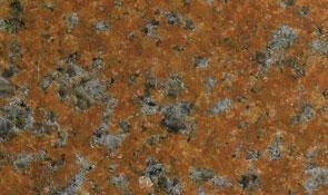 Close-up of textured granite stone with a speckled pattern of rusty orange, gray, and black mineral grains.