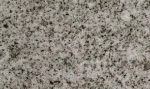 Close-up of a granite surface with a speckled pattern of black, gray, and white mineral grains.