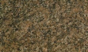 A close-up view of polished granite stone with a mottled, speckled texture in shades of tan, brown, black, and beige.