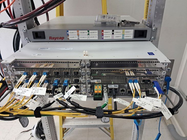A man is working on a server in a data center