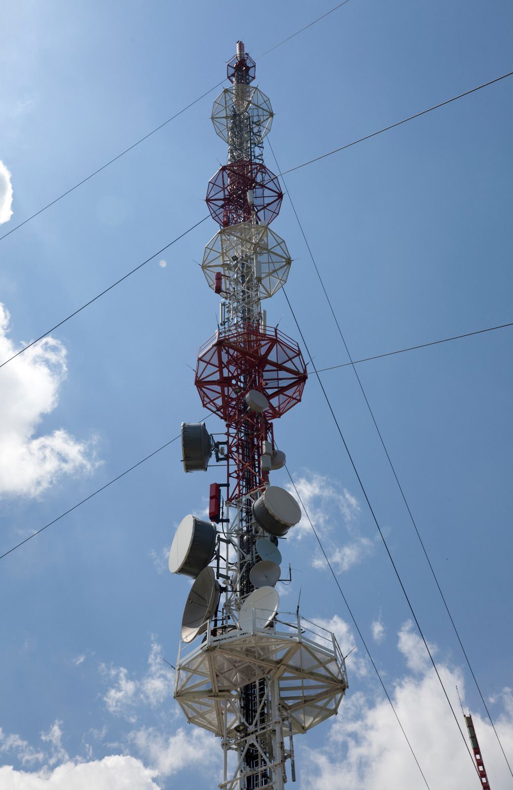 A very tall tower with a lot of antennas on it