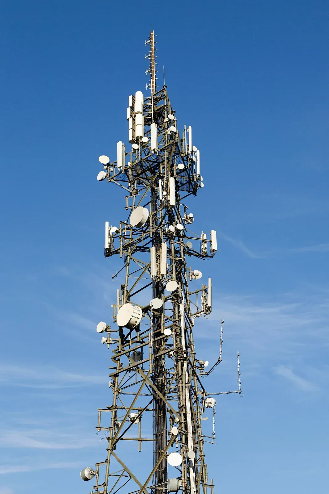 A very tall tower with a lot of antennas on it
