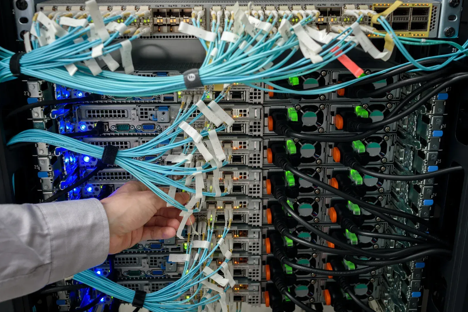 A person is working on a server in a data center.