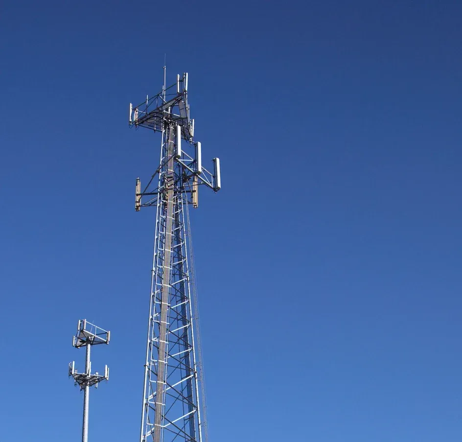 A telephone tower with a blue sky in the background