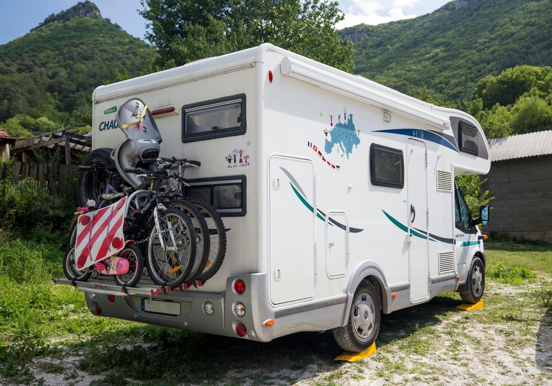 small RV parked in town with couple