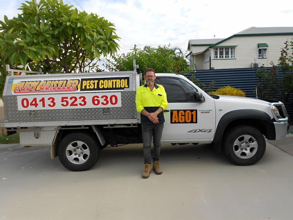 A Man Standing in Front of a White Truck That Says Ag01 — Audy Geiszler Pest Control in Bowen, QLD