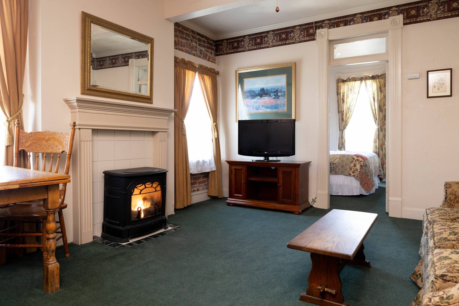 A living room with a fireplace and a flat screen tv