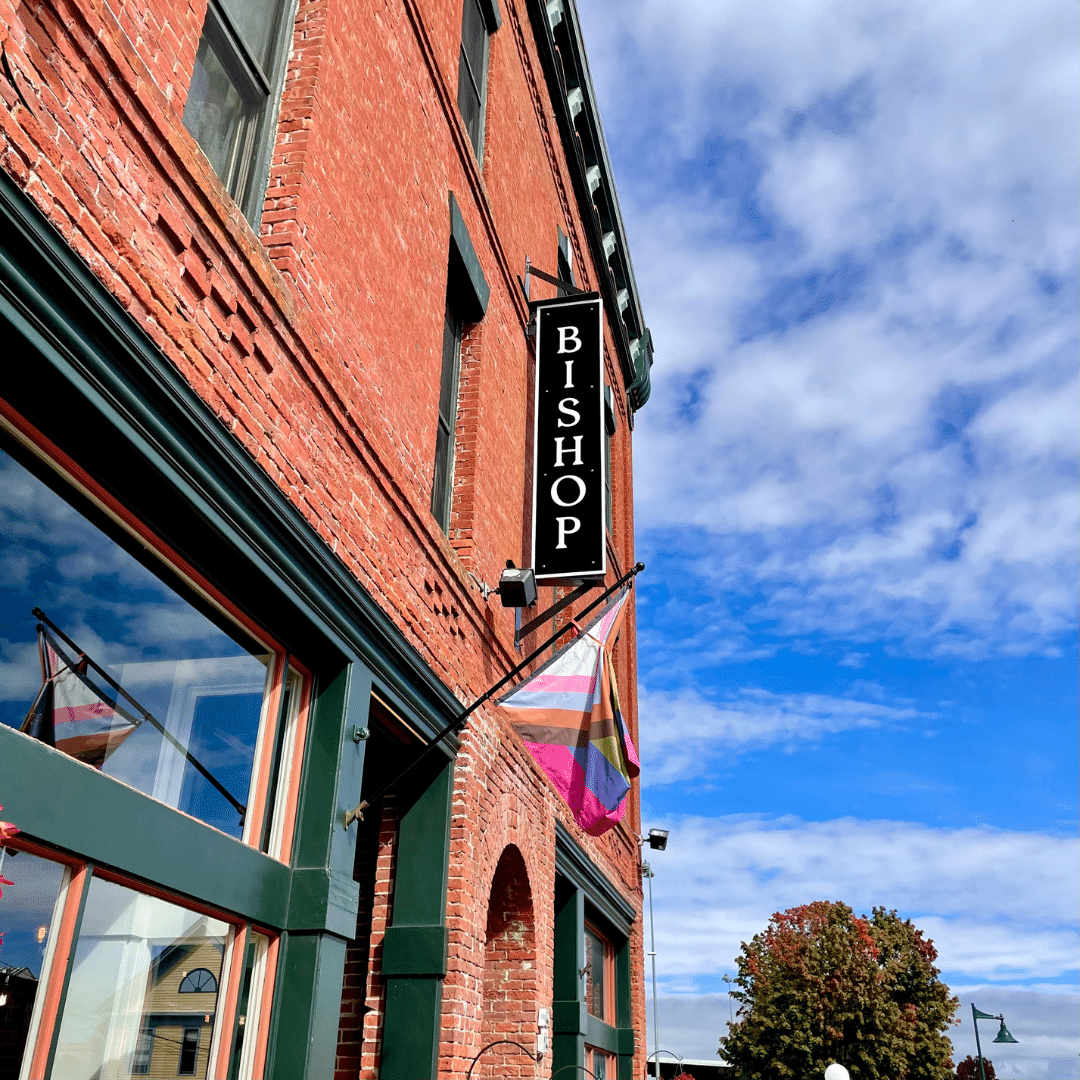 A brick building with a green awning that says ' bakery ' on it