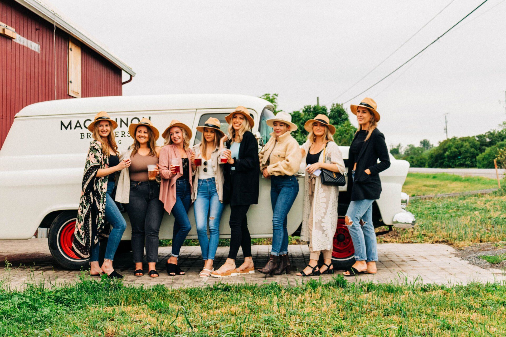 A group standing in front of van at Mackinnon Brother's Brewing