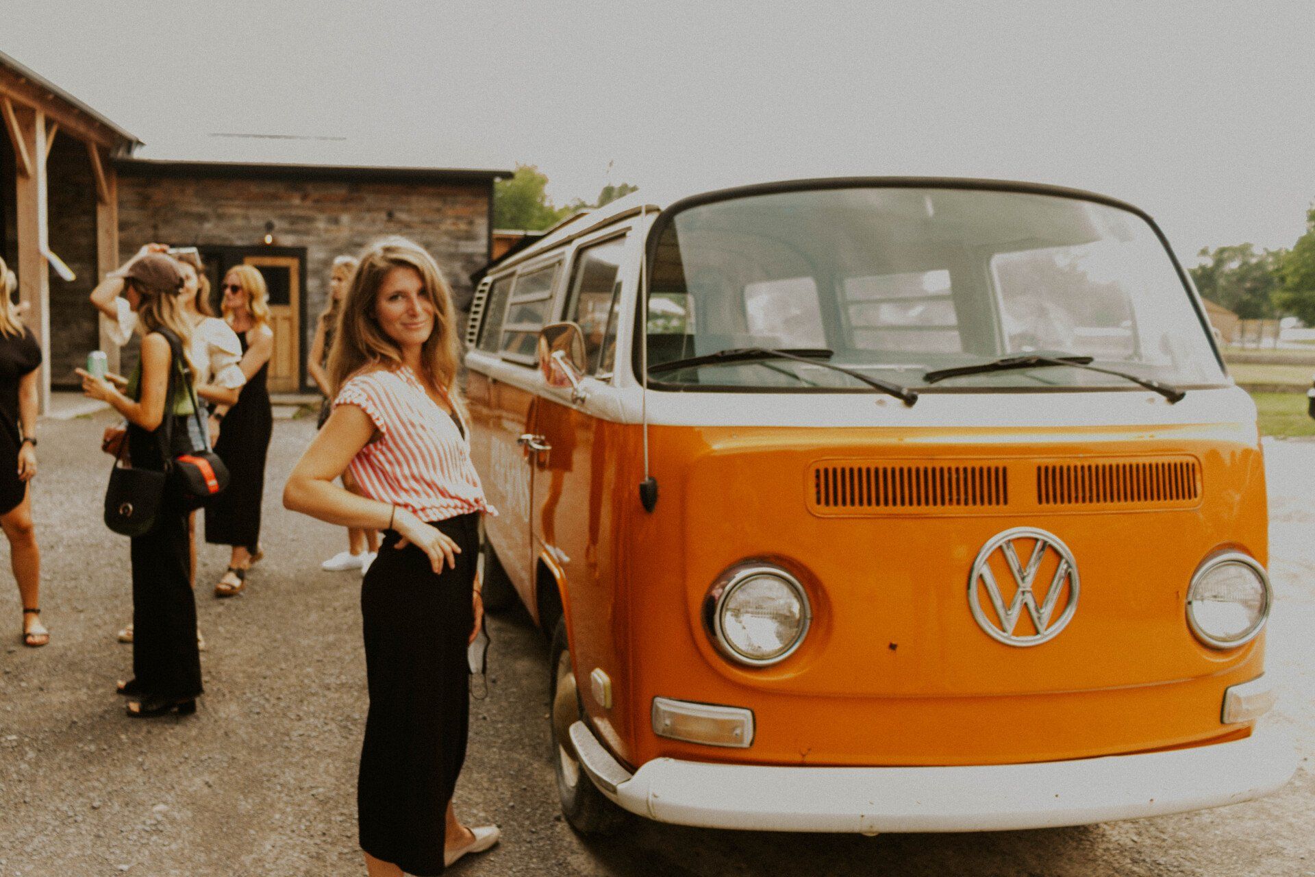 Woman standing beside bus on her PEC wine tour